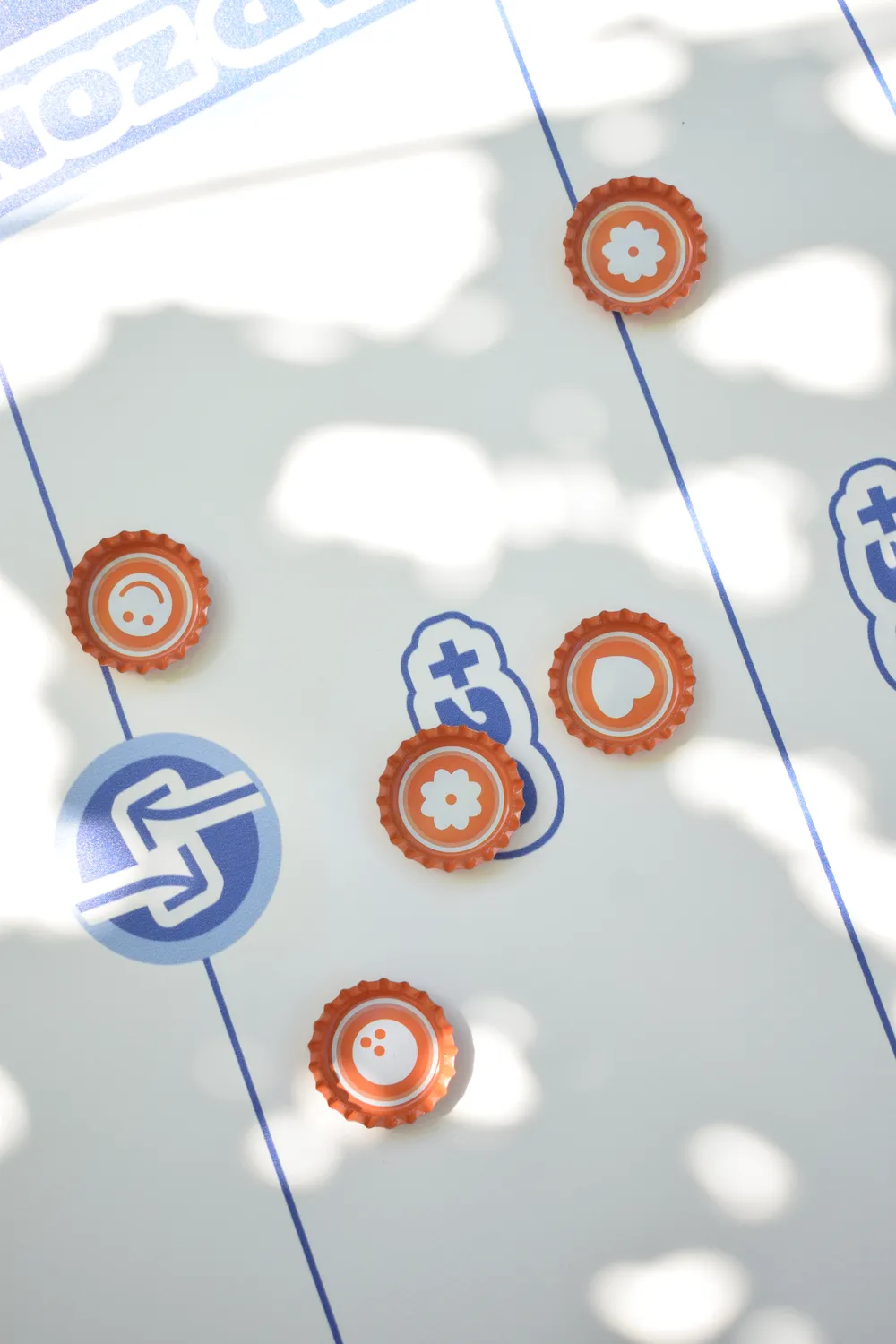 Comme des capsules de bières, les capsules de jeu 111 servent de jetons pour le jeu d'adresse et de précision Le 111. Les équipes Smiley, Fleur, Coeur et Bowling sont imprimées à l'intérieur de ces capsules pour différencier les équipes.